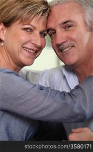 Smiling mature couple hugging tenderly