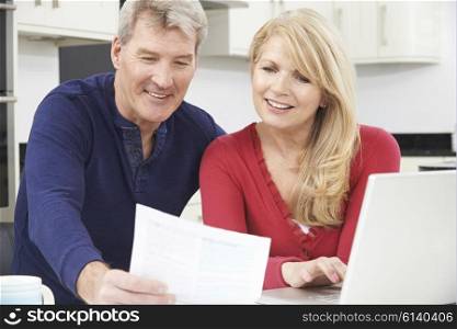 Smiling Mature Couple Reviewing Domestic Finances