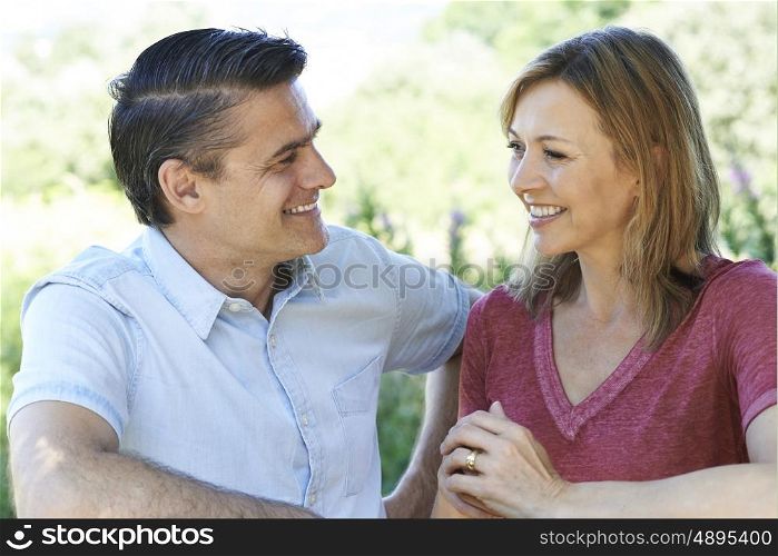 Smiling Mature Couple Talking To One Another Outdoors