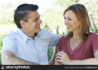 Smiling Mature Couple Talking To One Another Outdoors