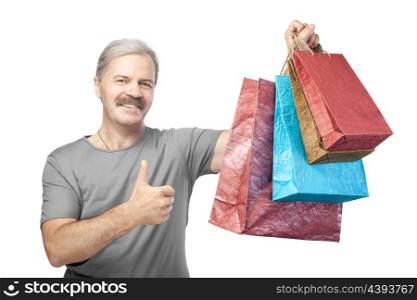 smiling mature man holding shopping bags isolated on white background
