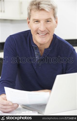 Smiling Mature Man Reviewing Domestic Finances