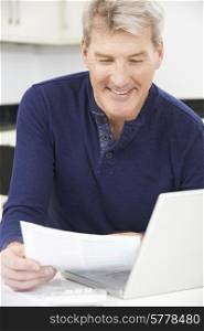 Smiling Mature Man Reviewing Domestic Finances