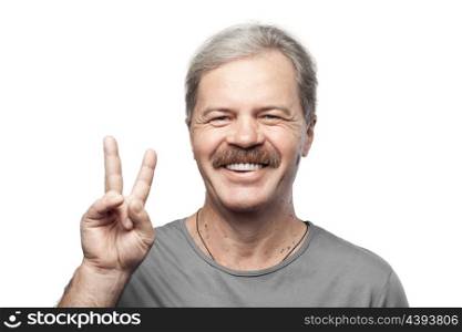 smiling mature man showing victory sign isolated on white background