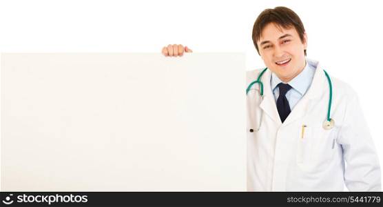 Smiling medical doctor holding blank billboard isolated on white&#xA;
