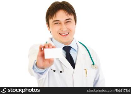 Smiling medical doctor holding blank business card in hand isolated on white&#xA;