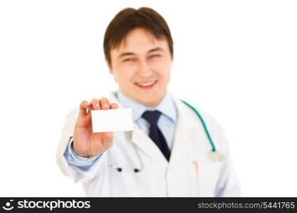 Smiling medical doctor holding blank business card in hand isolated on white&#xA;