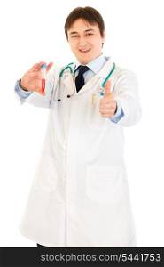 Smiling medical doctor holding blood sample and showing thumbs up gesture isolated on white&#xA;