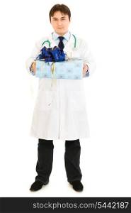 Smiling medical doctor holding gift in hands isolated on white&#xA;