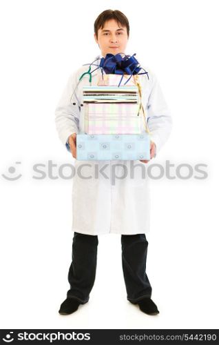 Smiling medical doctor holding gifts in hands isolated on white&#xA;