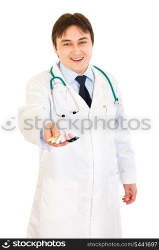 Smiling medical doctor holding packs of pills in hand isolated on white&#xA;