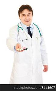 Smiling medical doctor holding packs of pills in hand isolated on white&#xA;
