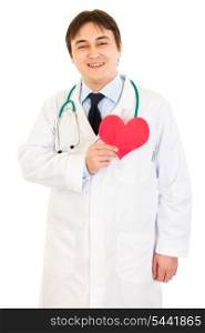 Smiling medical doctor holding paper heart near chest isolated on white&#xA;