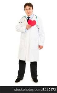 Smiling medical doctor holding paper heart near chest isolated on white&#xA;