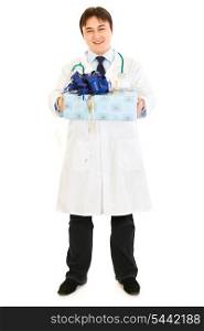Smiling medical doctor holding present in hands isolated on white&#xA;