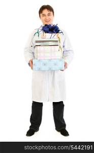 Smiling medical doctor holding presents in hands isolated on white&#xA;
