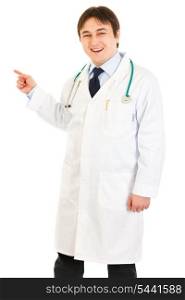 Smiling medical doctor pointing finger at something isolated on white&#xA;