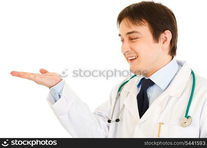 Smiling medical doctor presenting something on empty hand isolated on white&#xA;