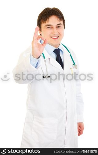 Smiling medical doctor showing ok gesture isolated on white&#xA;