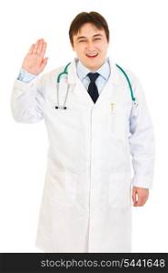 Smiling medical doctor showing salutation gesture isolated on white&#xA;