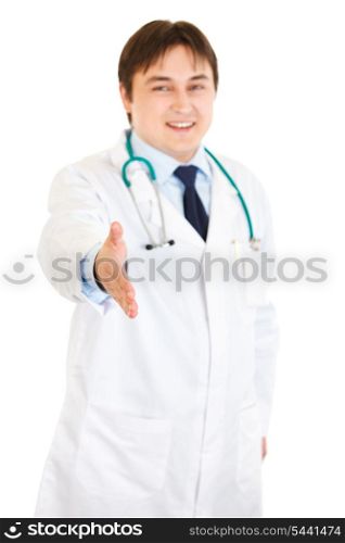 Smiling medical doctor stretches out hand for handshake isolated on white&#xA;