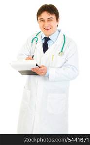 Smiling medical doctor with stethoscope making notes in document isolated on white&#xA;