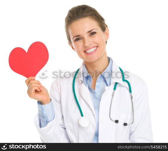 Smiling medical doctor woman holding paper heart