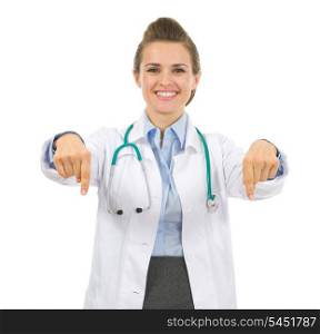 Smiling medical doctor woman pointing down