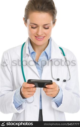 Smiling medical doctor woman reading sms