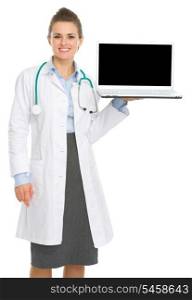 Smiling medical doctor woman showing laptop with blank screen