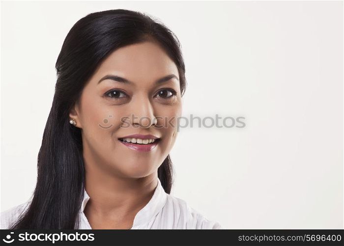 Smiling mid adult woman over white background
