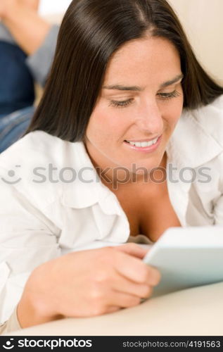 Smiling mid-aged woman read book on sofa in lounge