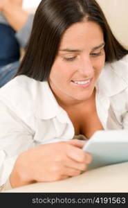 Smiling mid-aged woman read book on sofa in lounge