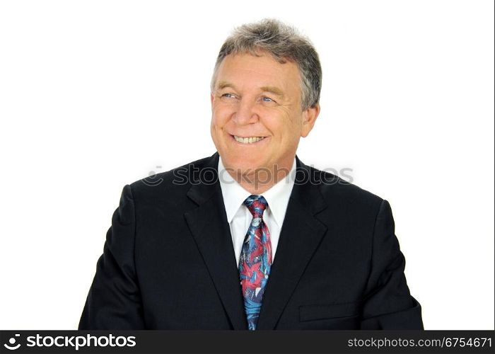 Smiling middle aged businessman looking away from camera.