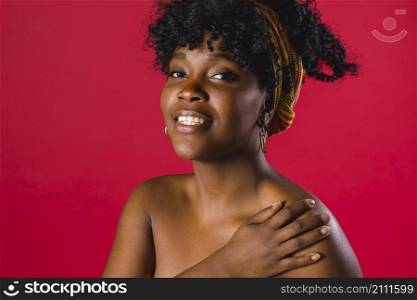 smiling naked black curly young female colored background