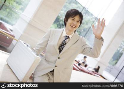 Smiling office worker waving a hand
