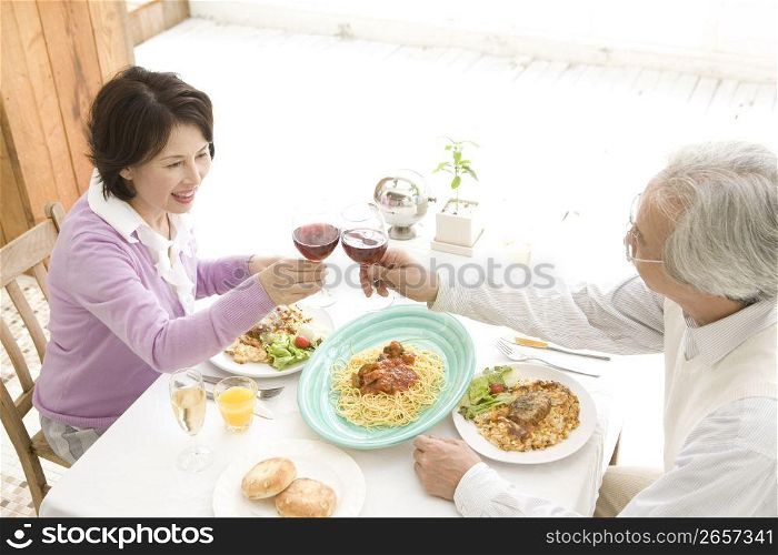 Smiling old asian couple eating