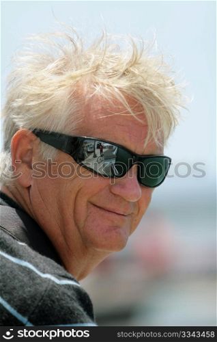 smiling older man with sun glasses