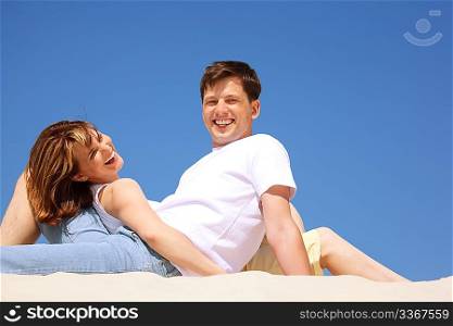 smiling pair in white shirts on the beach