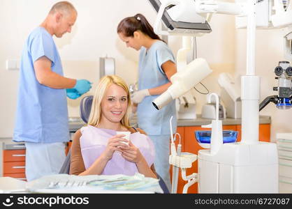 Smiling patient woman sitting at dentist surgery