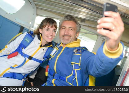 smiling people ready to jump from an airplane