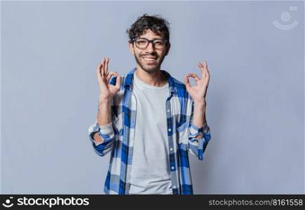 Smiling person gesturing OK in sign language, Interpreter man gesturing OK in sign language. Young man gesturing OK in sign language isolated. Manual gestures of people with hearing problems