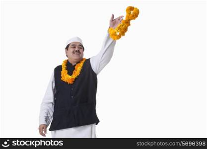 Smiling politician throwing garland