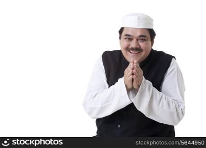 Smiling politician with hands clasped