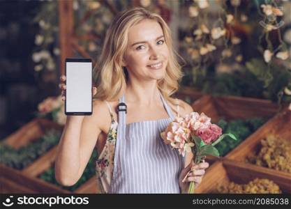 smiling portrait blonde young woman holding bouquet hand showing mobile phone