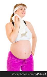 Smiling pregnant female wiping her face with towel after exercising&#xA;
