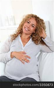 Smiling pregnant woman at home