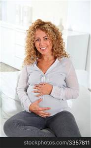 Smiling pregnant woman at home