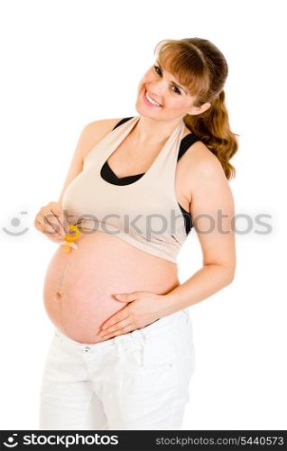 Smiling pregnant woman holding baby dummy near belly isolated on white&#xA;