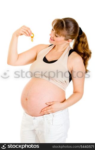 Smiling pregnant woman holding baby dummy near tummy isolated on white&#xA;